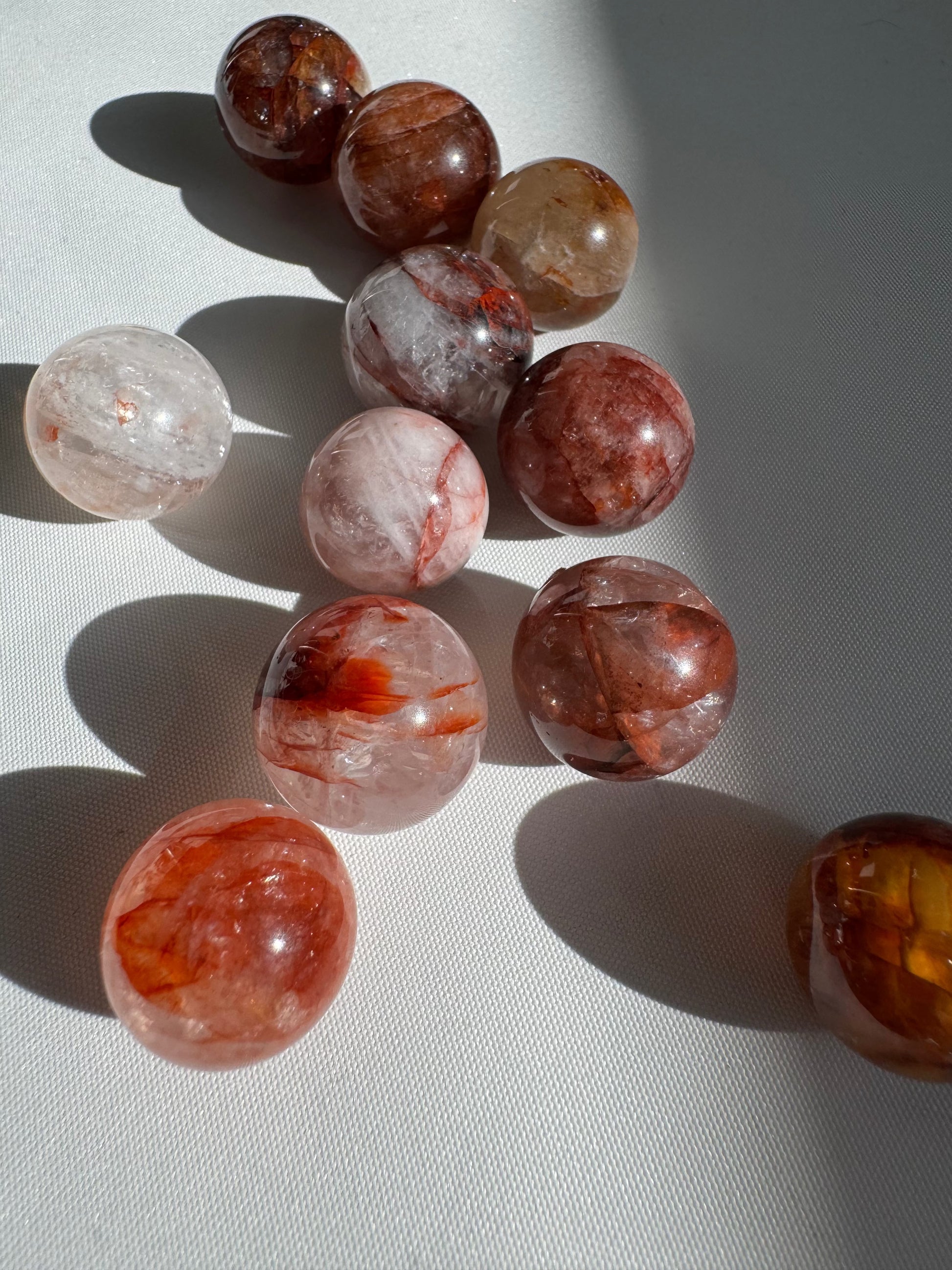Bespoke Mini Fire Quartz Crystal Spheres featuring natural rainbows and fiery hues, perfect for collectors and crystal healing enthusiasts.