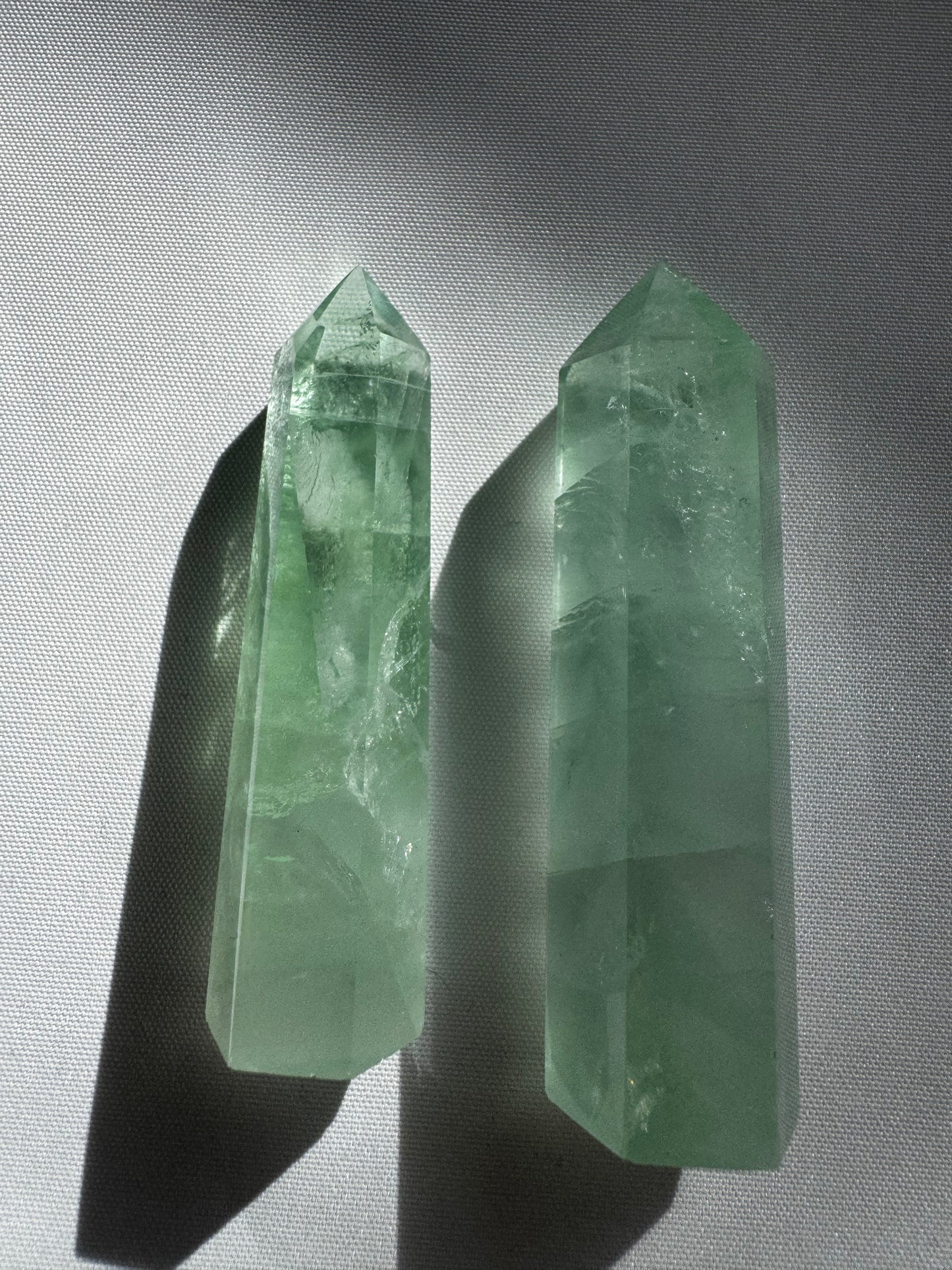 Pair of upright Green Fluorite Crystal Points with pointed tips, ideal for spiritual growth and energy alignment in crystal healing collections.