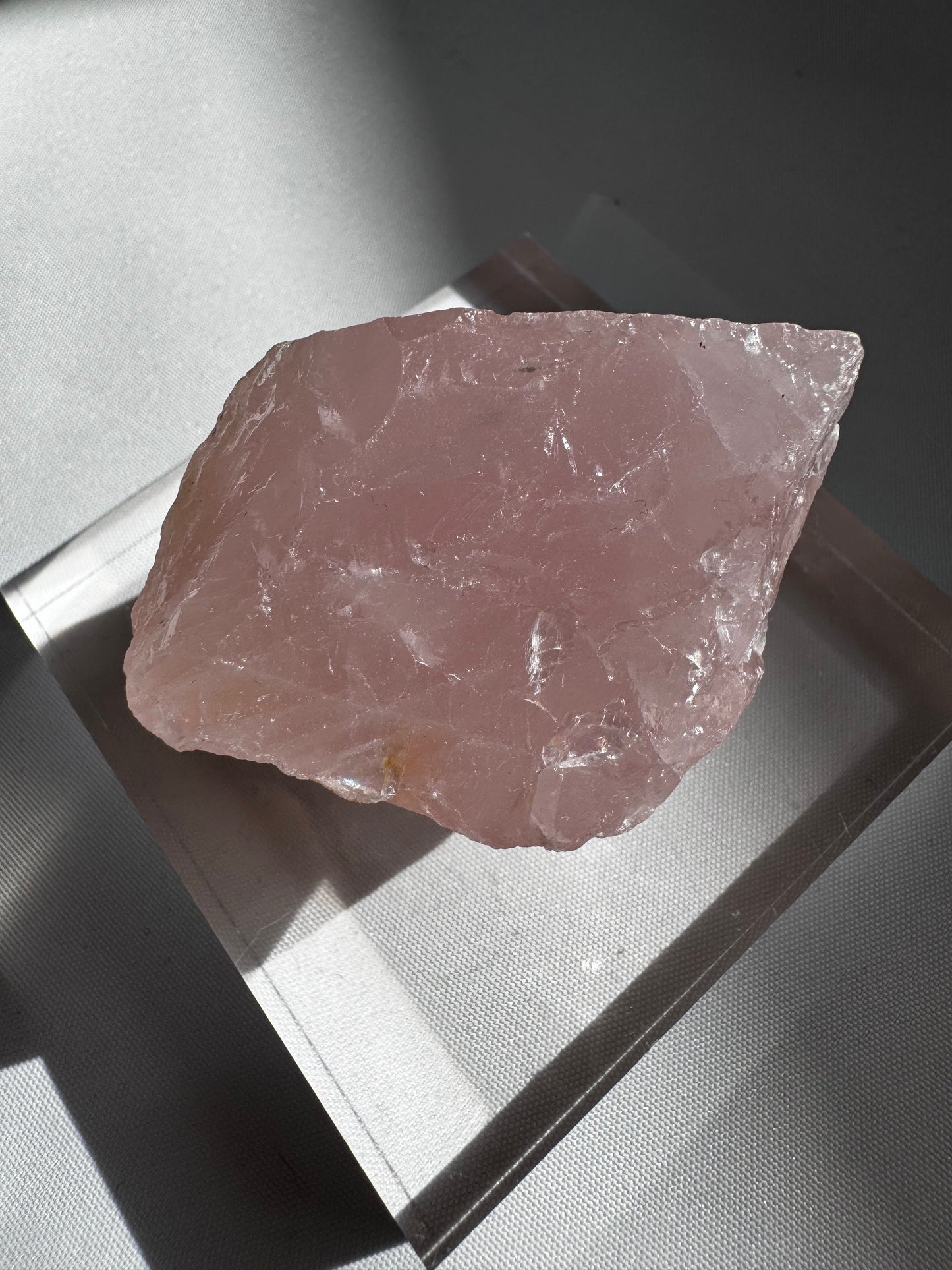 Single large raw rose quartz crystal on display | Bespoke Crystals
