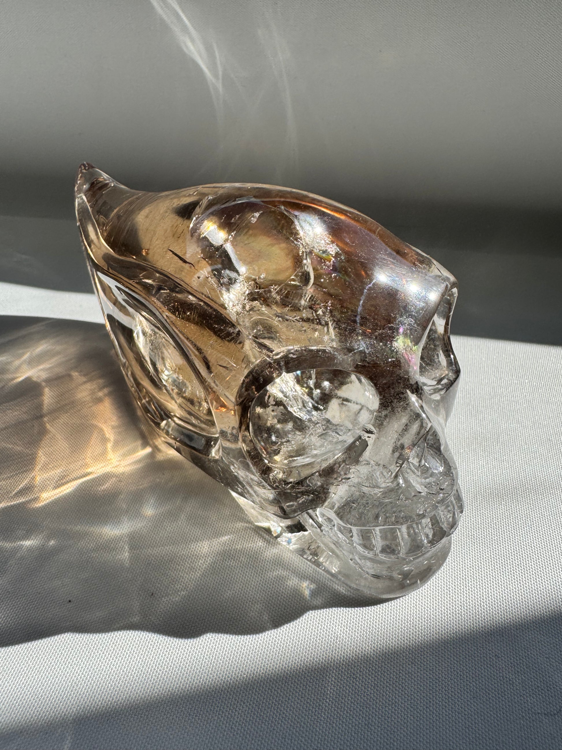 Close-up of glass skull with rainbow light effects