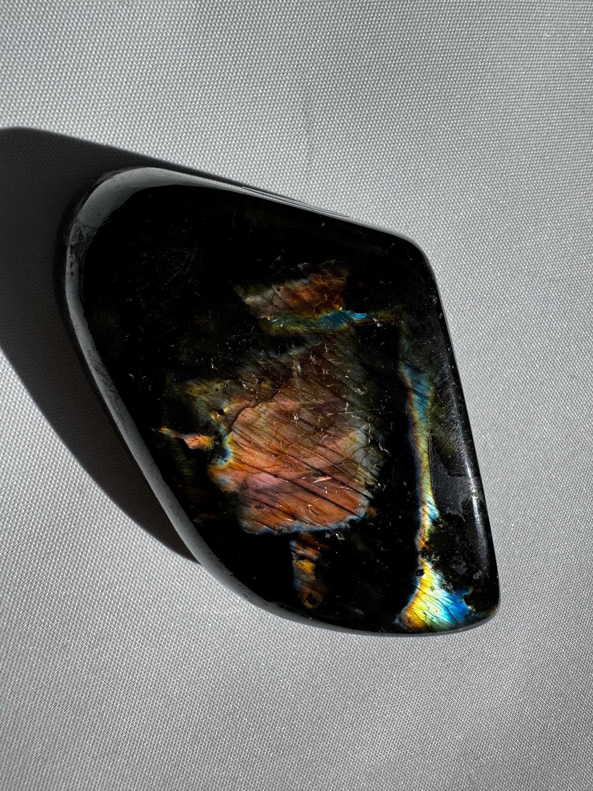 HQ Labradorite Crystal Freeform #L26 with vibrant blue and gold flash on polished surface, ideal for collectors and crystal healing enthusiasts.