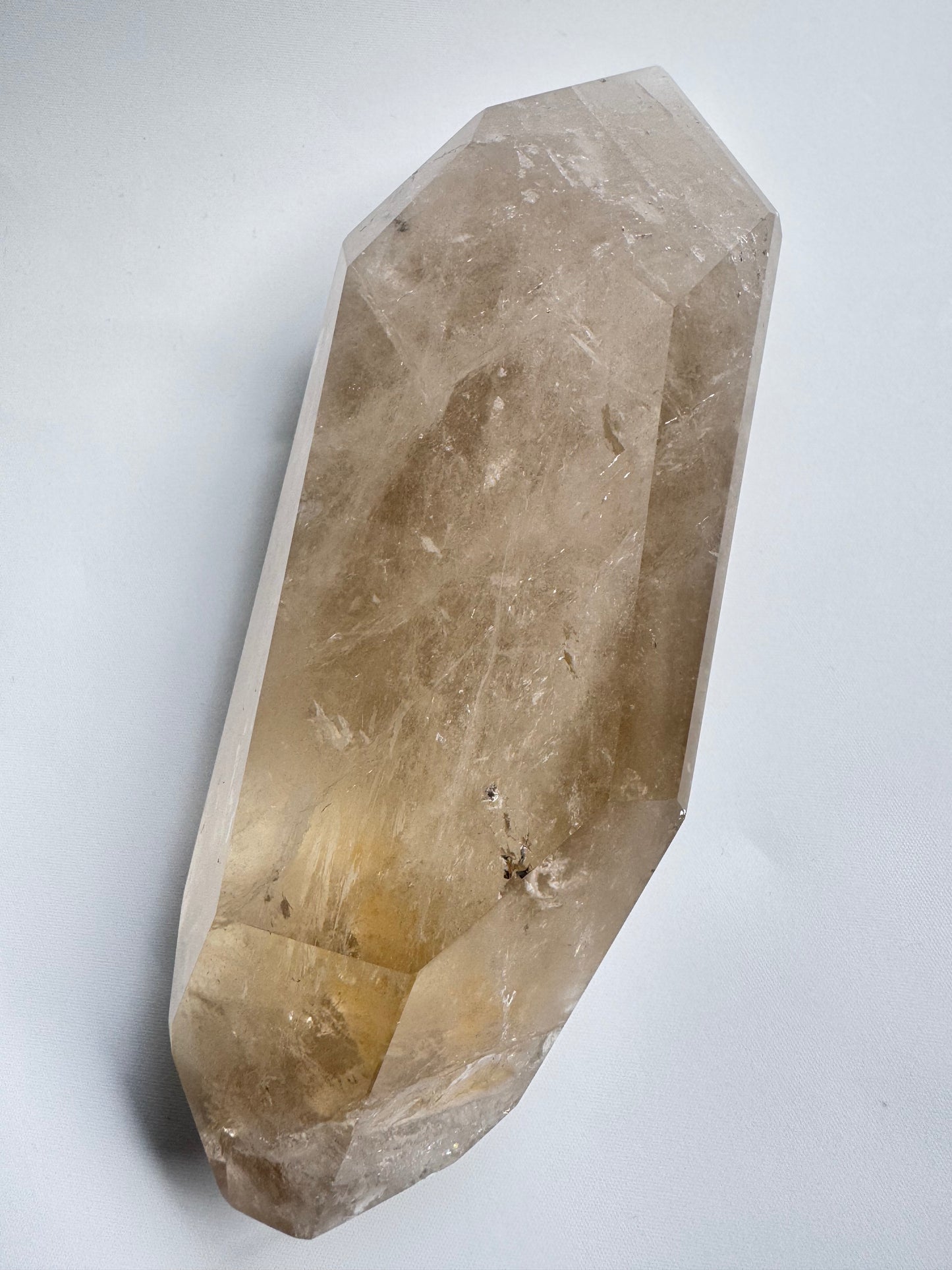 Brazilian Citrine gemstone lying flat, revealing internal inclusions and natural golden clarity ideal for collectors and crystal healing.