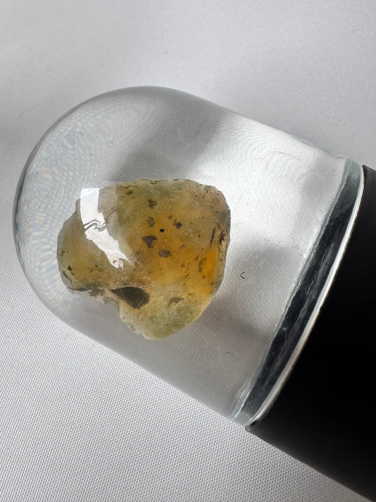 Bespoke Crystals-Welo Ethiopian Water Opal in display dome showing translucent body with subtle neon flashes and natural inclusions.