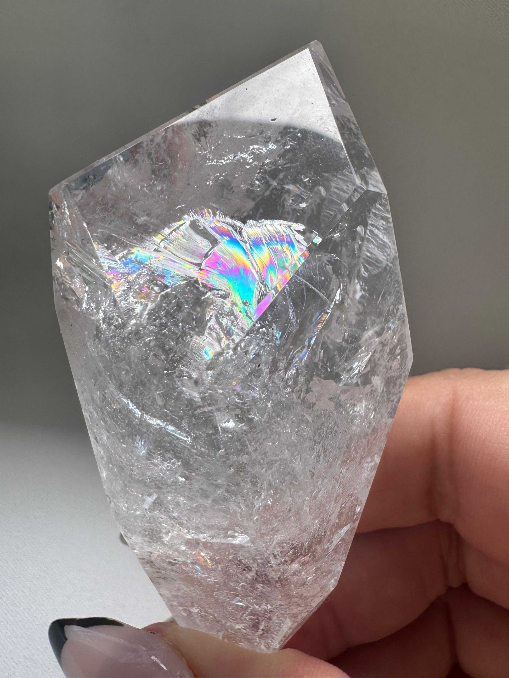 Close-up of Brazilian Quartz Freeform crystal with rainbow internal reflections | Healing Crystals NZ