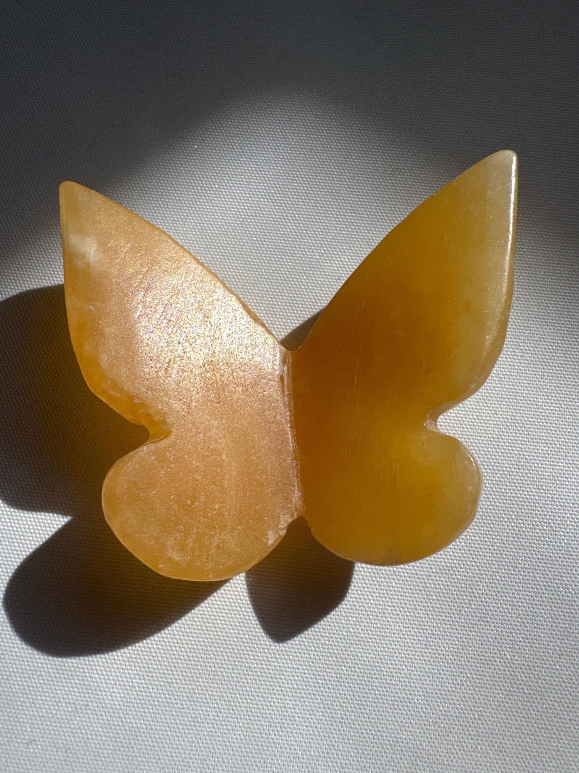 Hand-carved Orange Calcite Crystal 3D Butterfly with deep amber tones, perfect for autumn-themed rock and fossil collections.