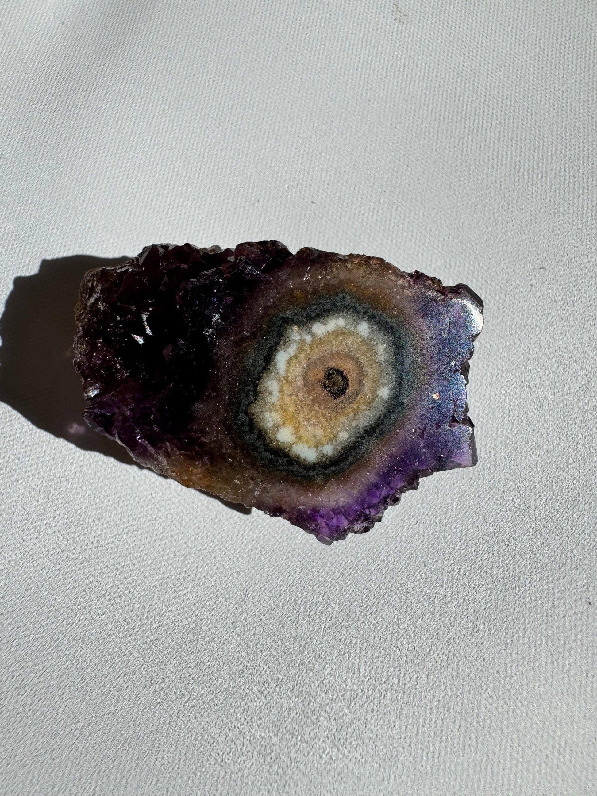Single Amethyst Crystal Stalactite Grade A featuring concentric rings of white, yellow, and purple, showcasing natural Brazilian geode formation.