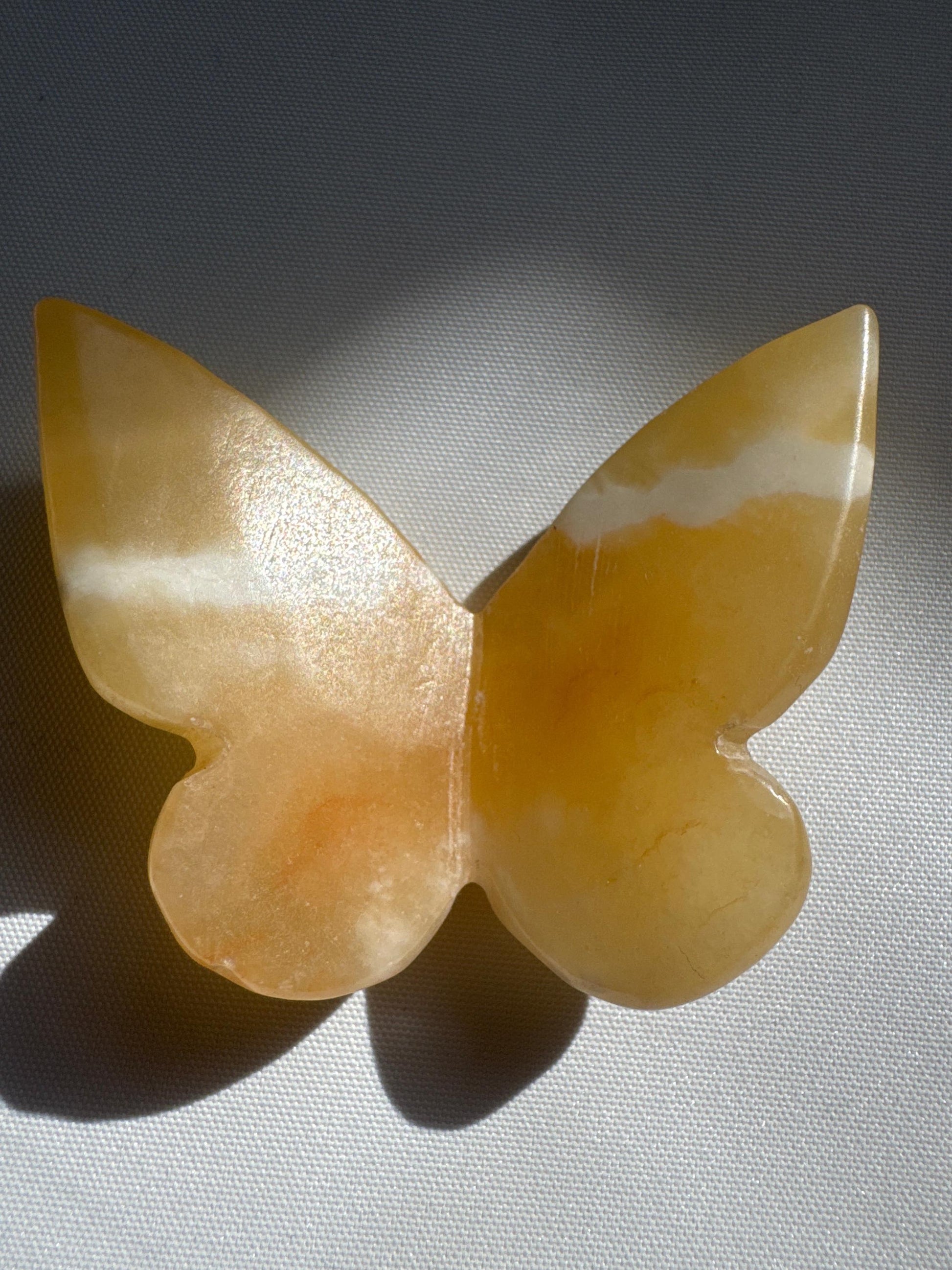 Unique Orange Calcite Crystal 3D Butterfly featuring natural white banding, enhancing its collectible and decorative value.