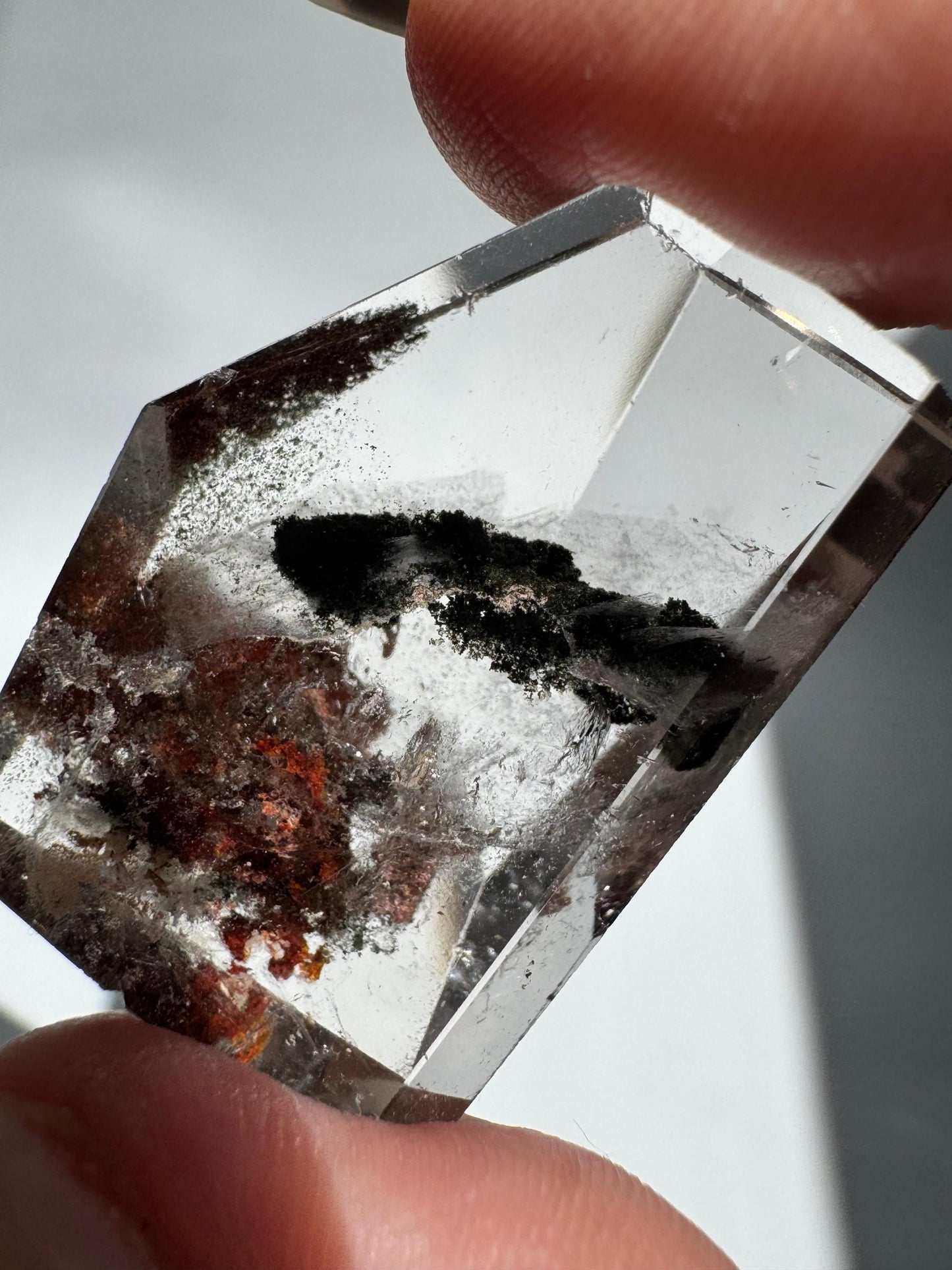 Transparent Lodalite Freeform gemstone featuring dark and earthy inclusions. Perfect for manifestation and spiritual practices in NZ.