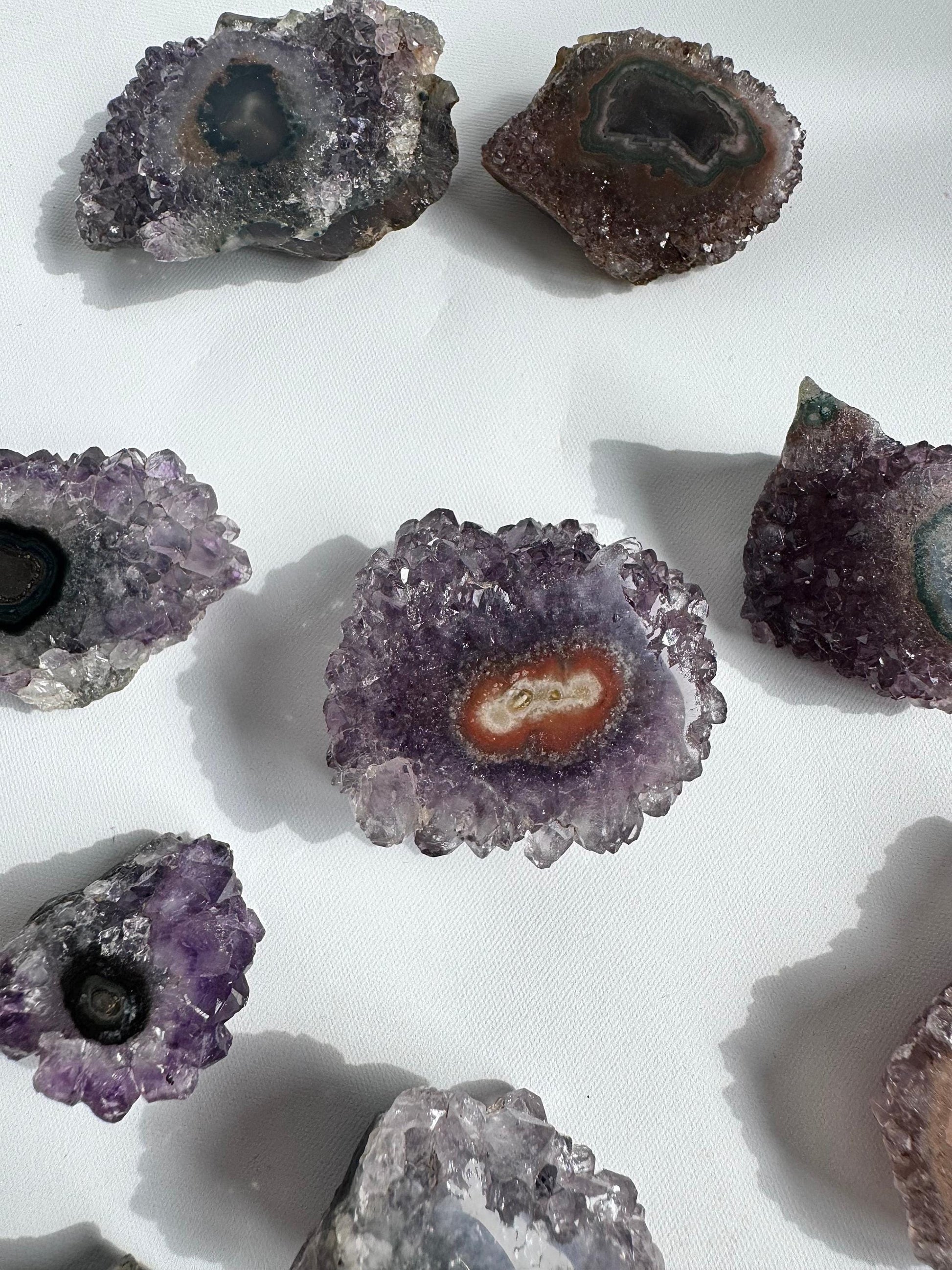 Collection of Amethyst Crystal Stalactites Grade A with vibrant violet cores and flower-like patterns, ideal for rock collectors and crystal enthusiasts.