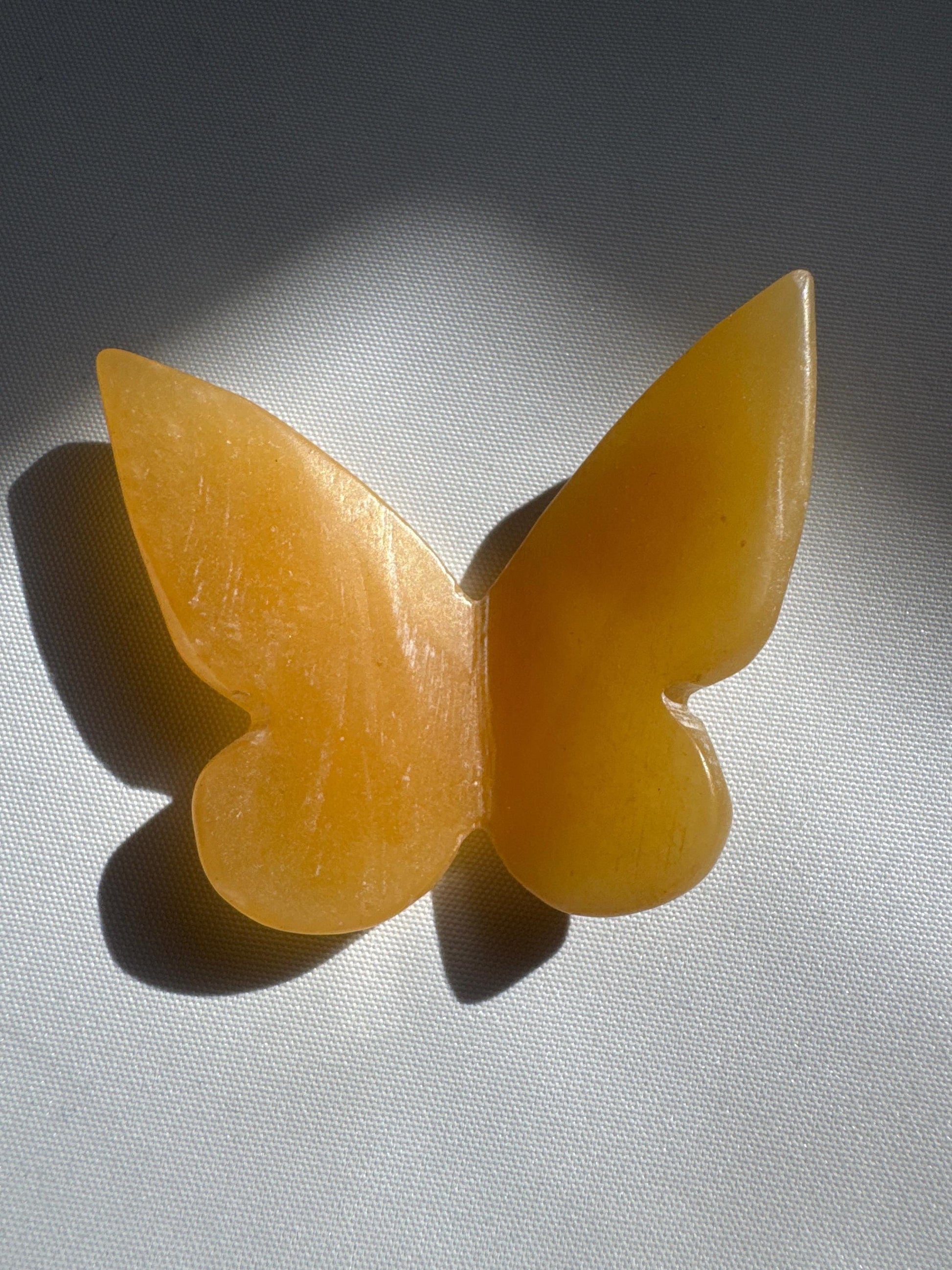Polished Orange Calcite Crystal 3D Butterfly with vivid orange glow, designed for decorative and metaphysical crystal enthusiasts.