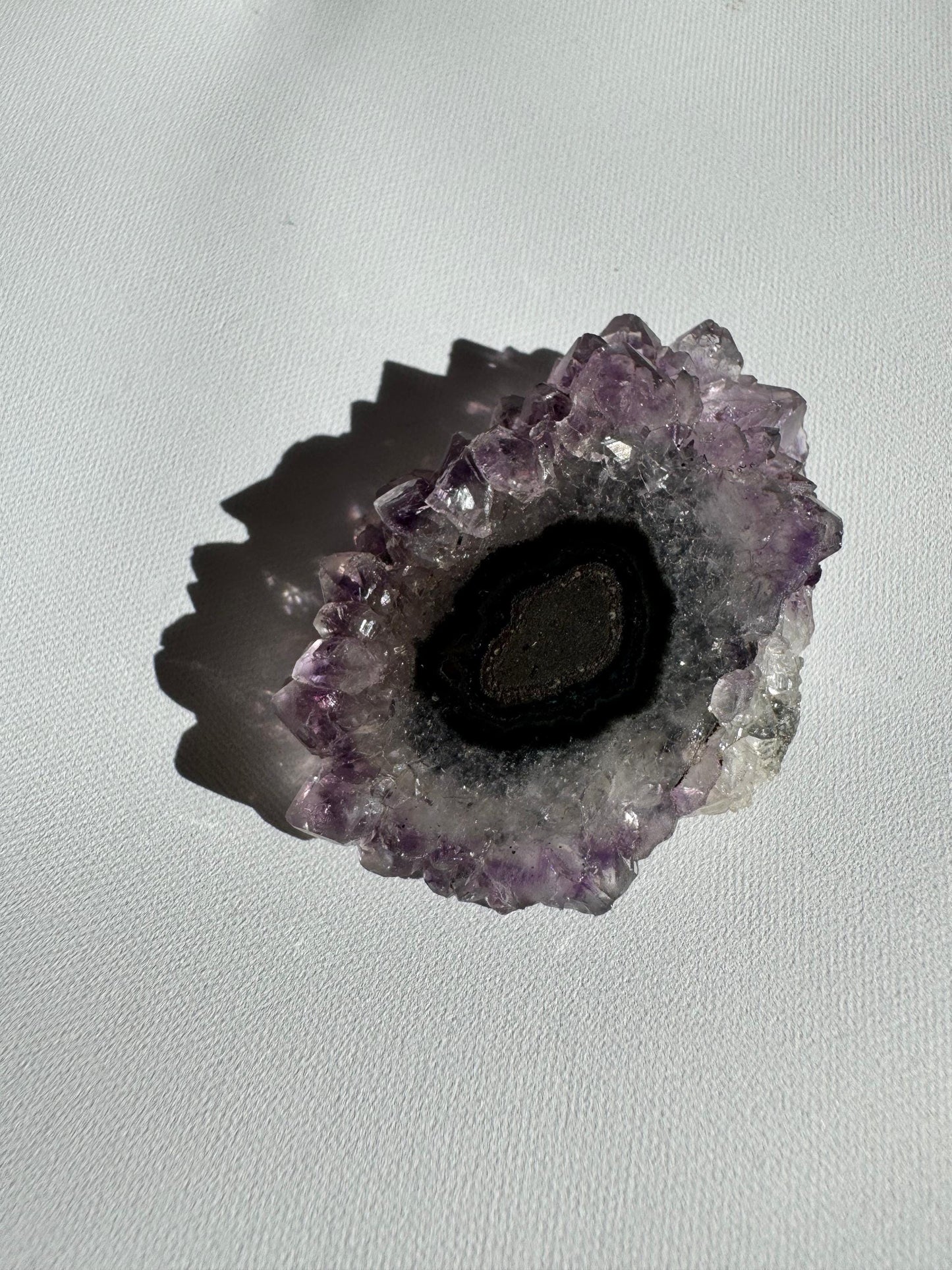 Dark-centered Amethyst Crystal Stalactite Grade A with black and grey concentric layers, ideal for rock and crystal collections.