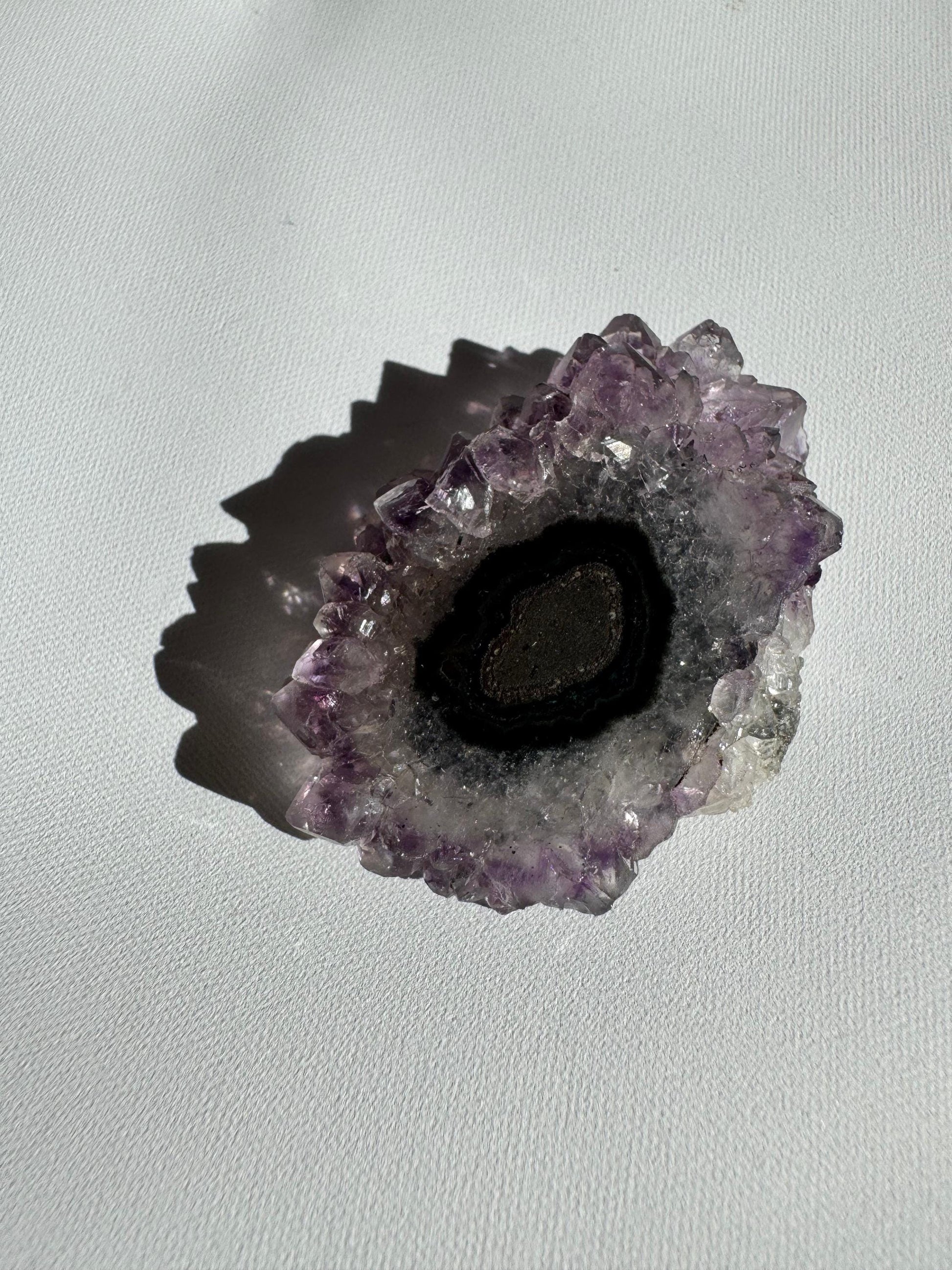 Dark-centered Amethyst Crystal Stalactite Grade A with black and grey concentric layers, ideal for rock and crystal collections.