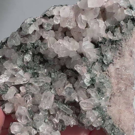 Close-up of Pink Lithium Quartz Cluster showcasing detailed Lemurian striations and calming crystal formations for spiritual wellness use.