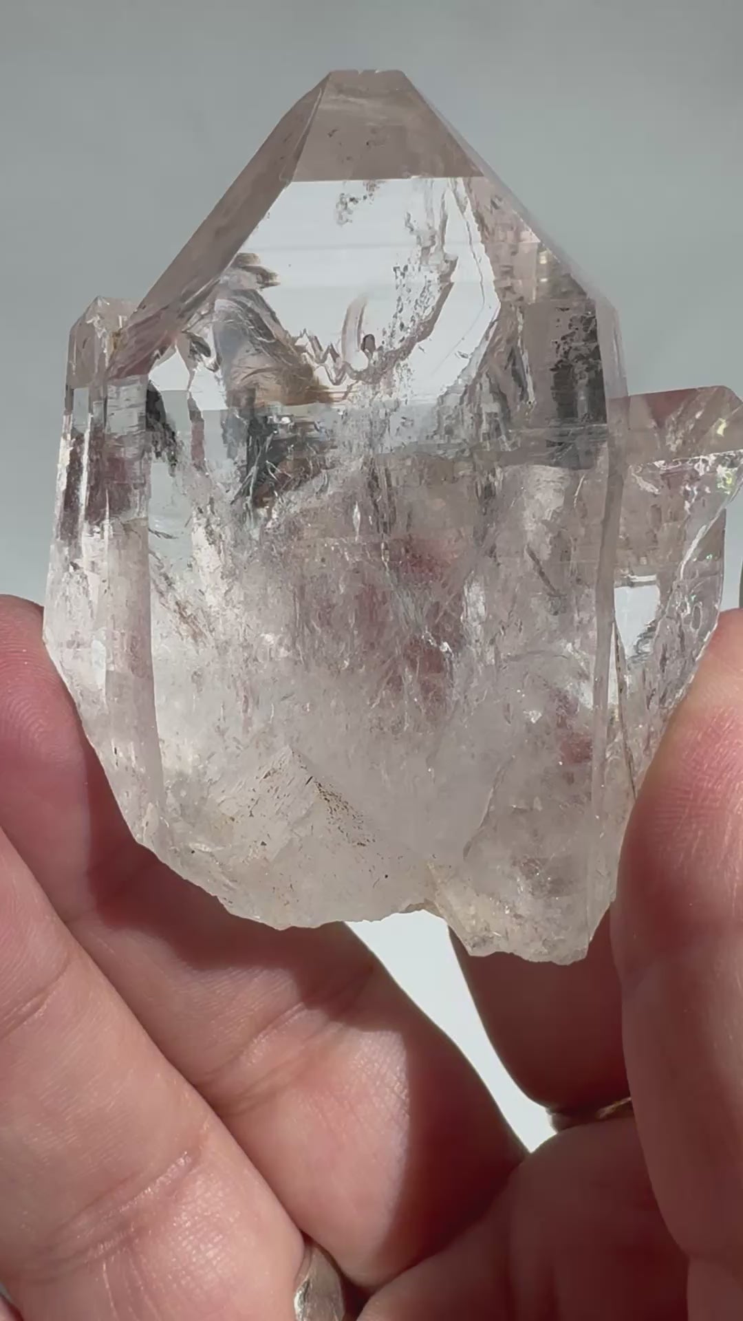 Close-up of Silver Light Lemurian Seed Crystal #5 held in hand, showcasing its clarity and natural formation. Ideal Lemurian Quartz for intuitive practices.
